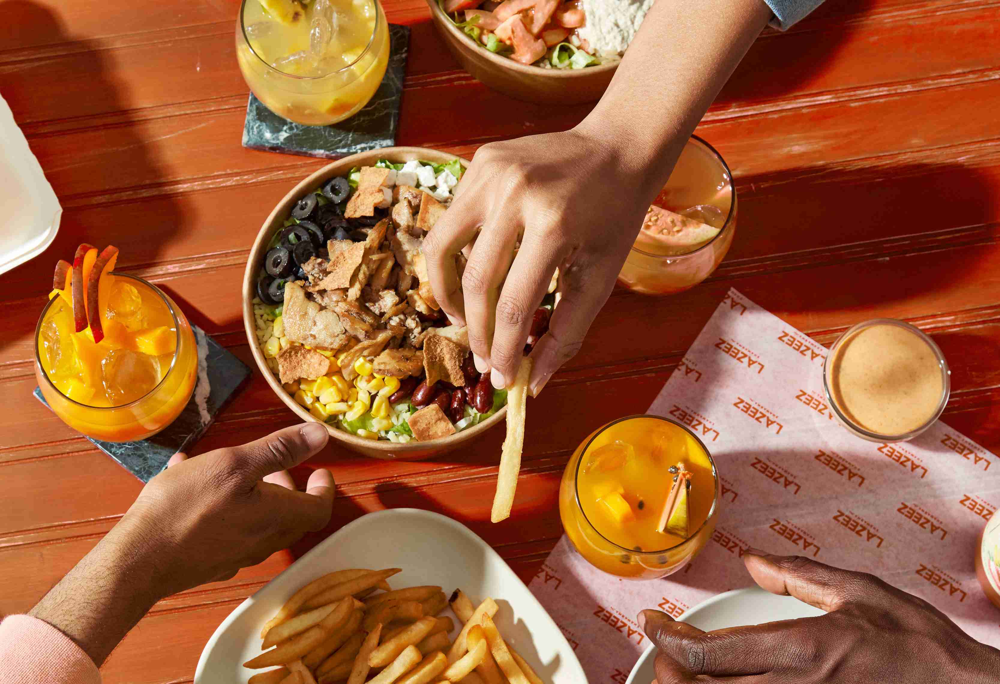 Lazeez community eating delicious yalla bowl and lazeez juices